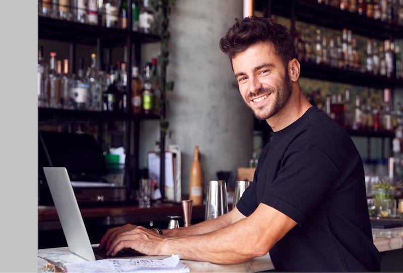 man using computer at the bar